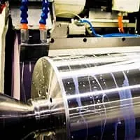 Cylindrical grinding operation with workpiece held between centers